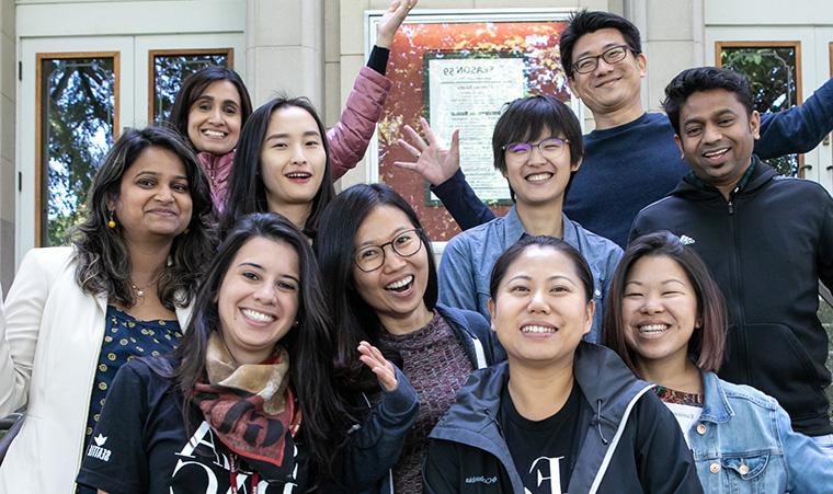 International students pose on the steps of McKinley Hall during orientation